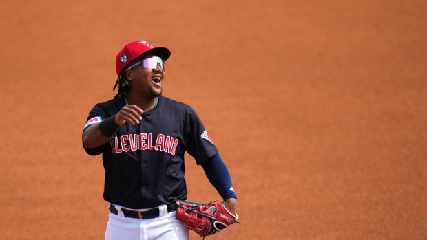 Cleveland Guardians third baseman Jose Ramirez (11) smiles as he takes the field in the first inning during an MLB spring training baseball game against the Cincinnati Reds, Saturday, Feb. 24, 2024, at Goodyear Ballpark in Goodyear, Ariz.